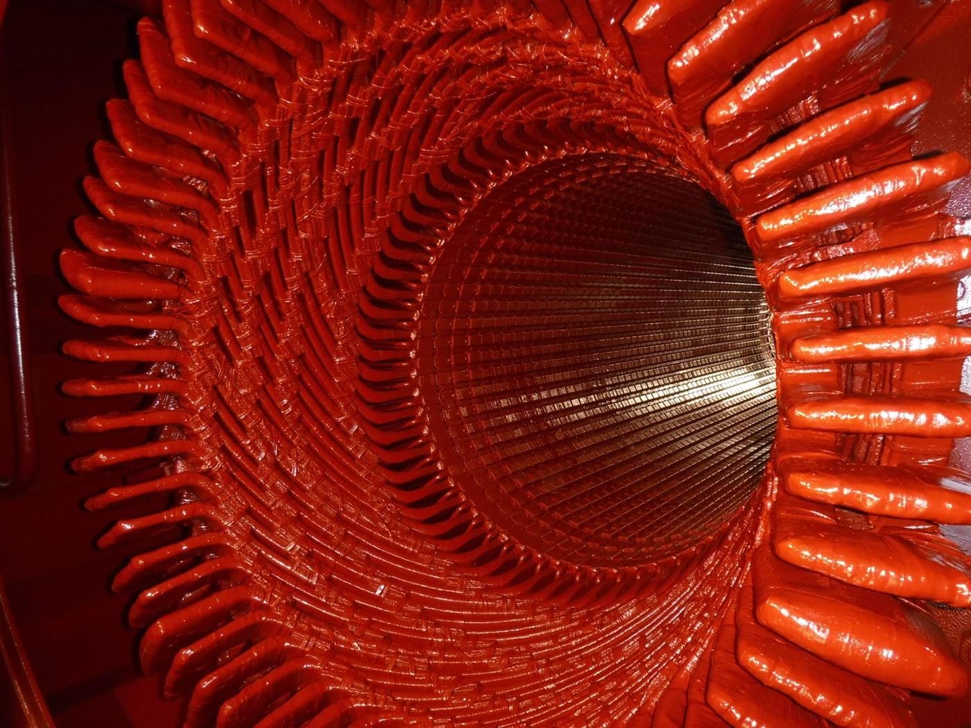 A turbine generator stator bore after rewind, end-windings coated and tied