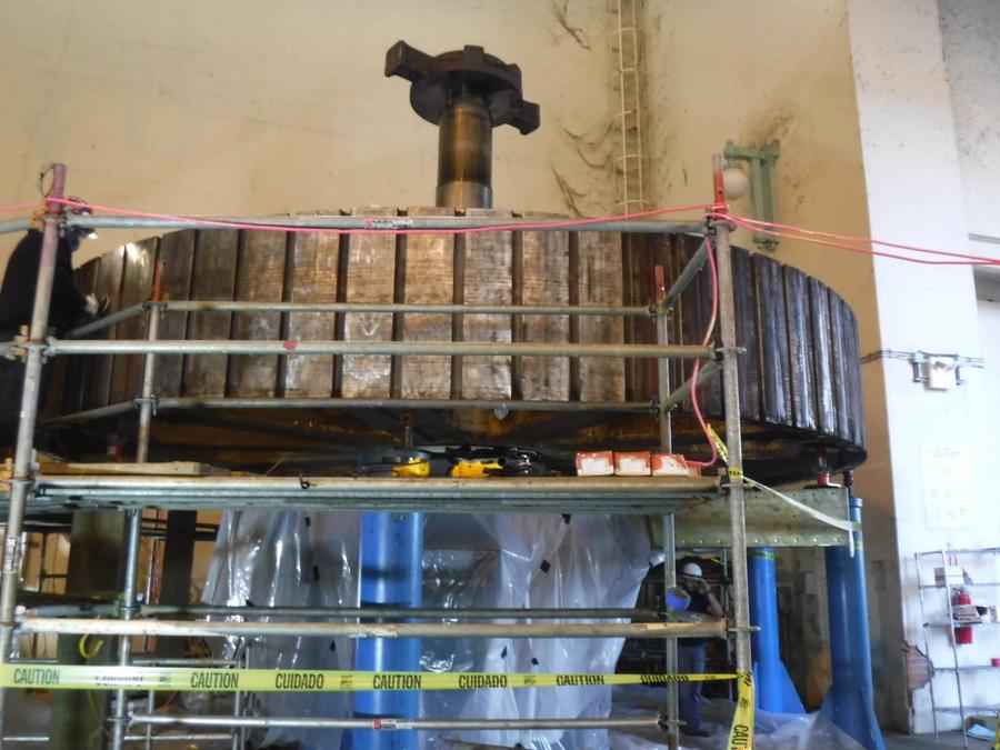 Scaffolding erected around a hydro generator rotor rim with the shaft above it